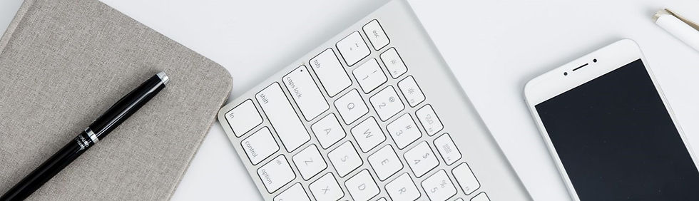 A computer case, pen, keyboard and smartphone on a white background.