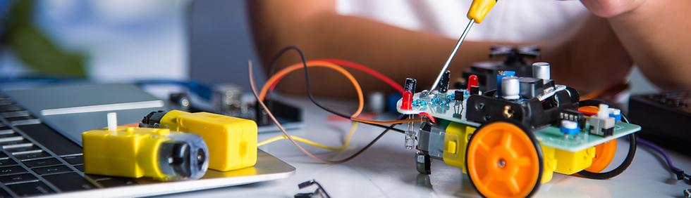 Student working on a robot with a small screwdriver
