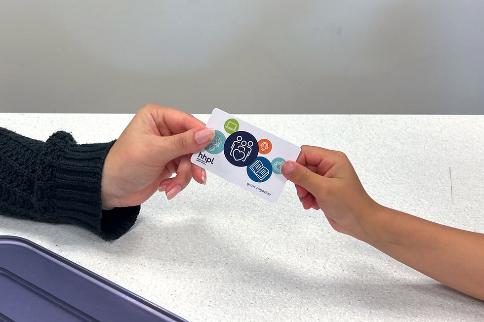 Hands exchanging a library card