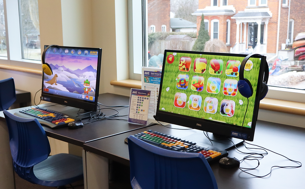 Two computer stations in front of a window. The screens are displaying games.
