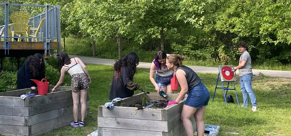 Children and adults planting in community garden