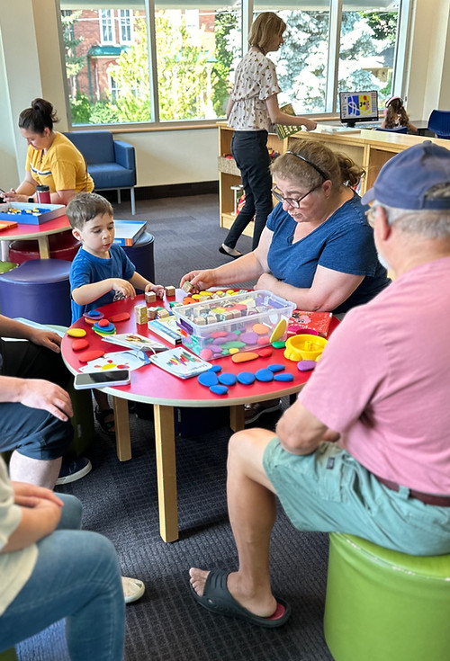 People playing with colorful blocks in a library