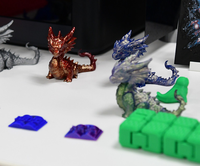 Colorful 3D printed dragons and various small models