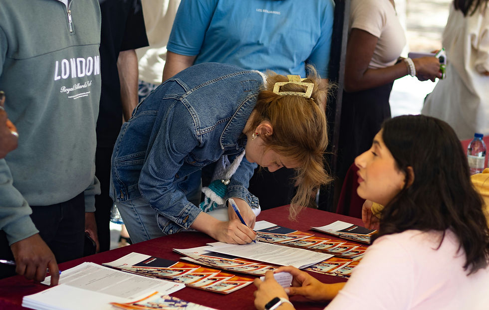 University and College Fair. Student signing up for something at a table.