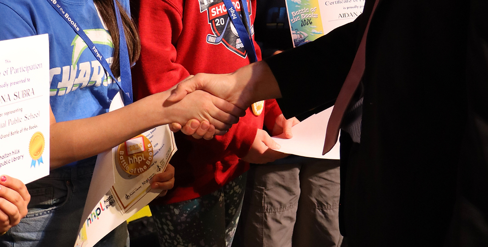 Adult shaking hands with a child winner