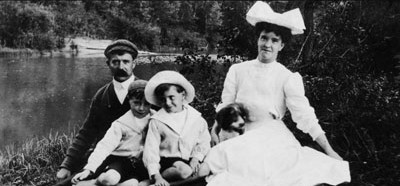 Family of five sitting by a lake