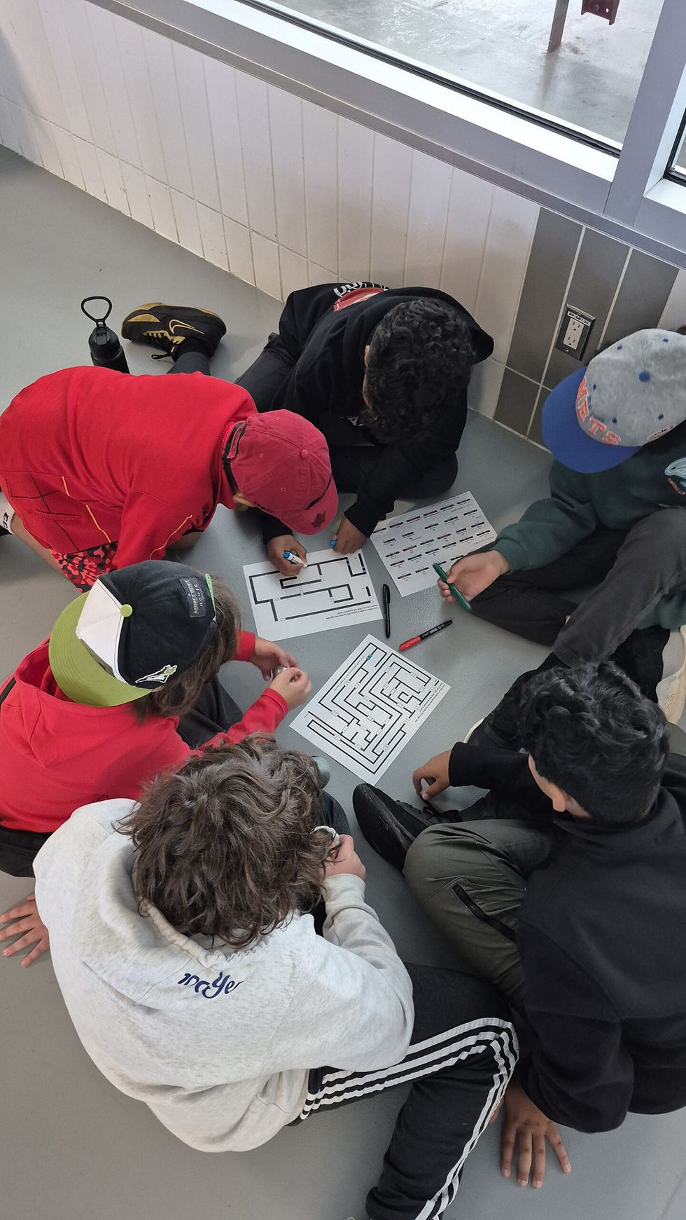 Young people engaged in group activity on floor
