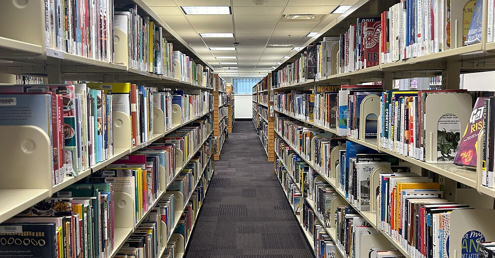 Long aisle in a library with bookshelves filled with books