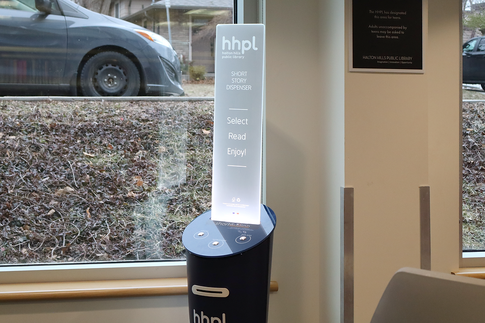 A short story dispenser next to the window.