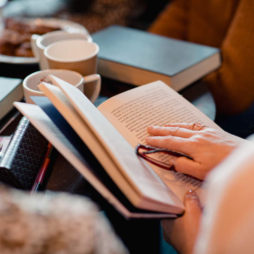 A person reading a book in their lap.