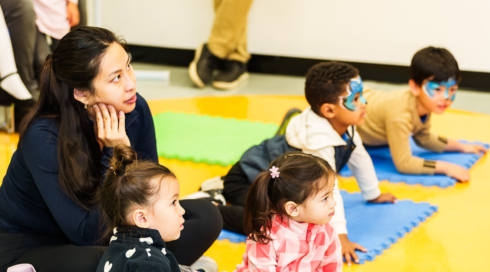 Adult and young children watching, some with face paint.