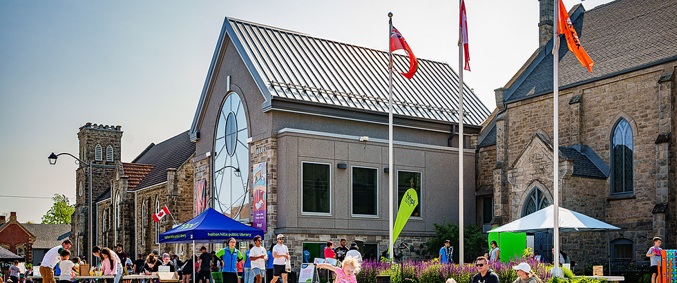 A crowd gathered outside the front entrance of the HHPL Georgetown Branch for an event.