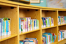 Curved bookshelf filled with colorful books