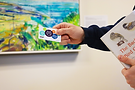 Hand holding library card and bird book