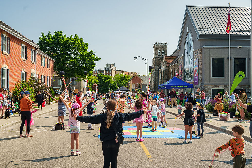 Children and families enjoying outdoor activities at a community street event.
