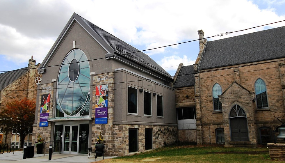 Stone library building with a large arched entrance