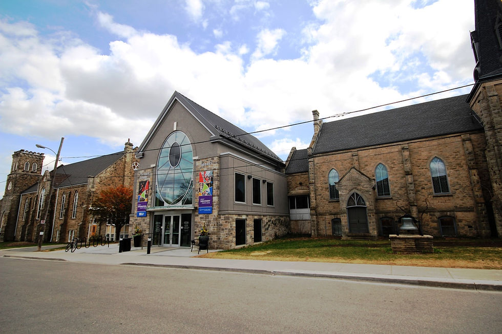 Large stone building with a prominent glass entrance