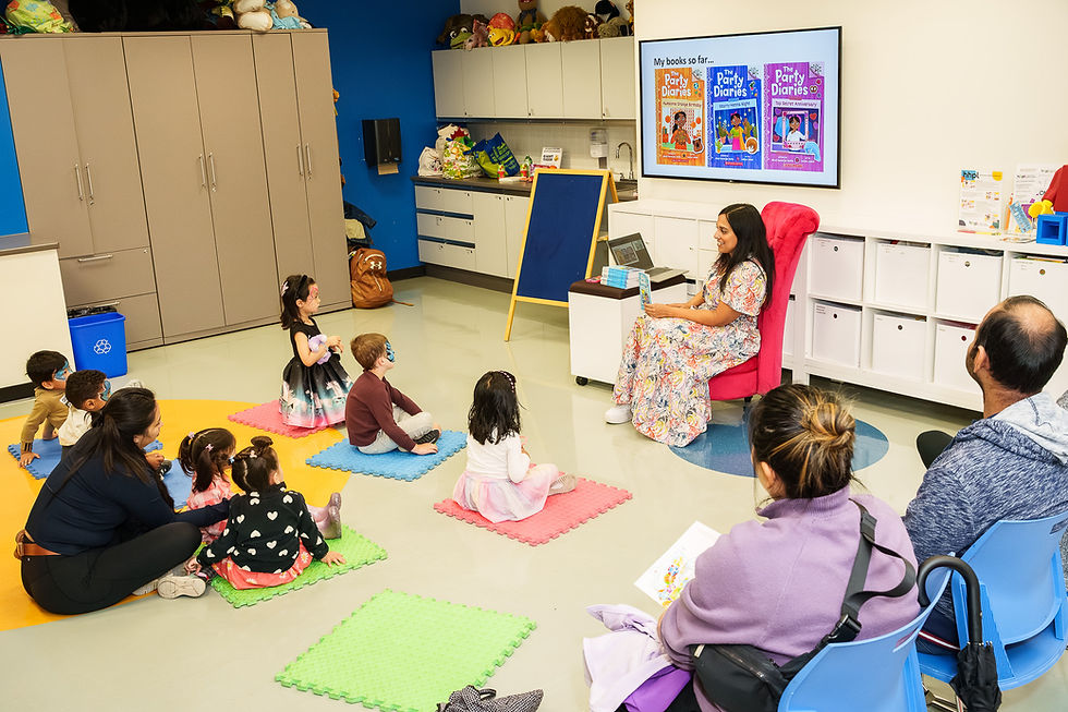 Woman reading to children and adults in a classroom