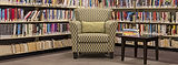 Library reading nook with armchair and books