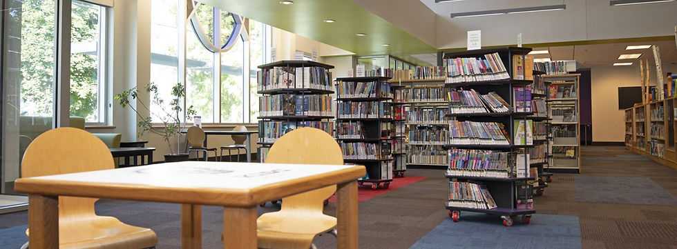 Modern library interior with bookshelves and wooden tables