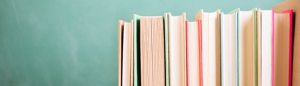 Row of colorful books on a teal background